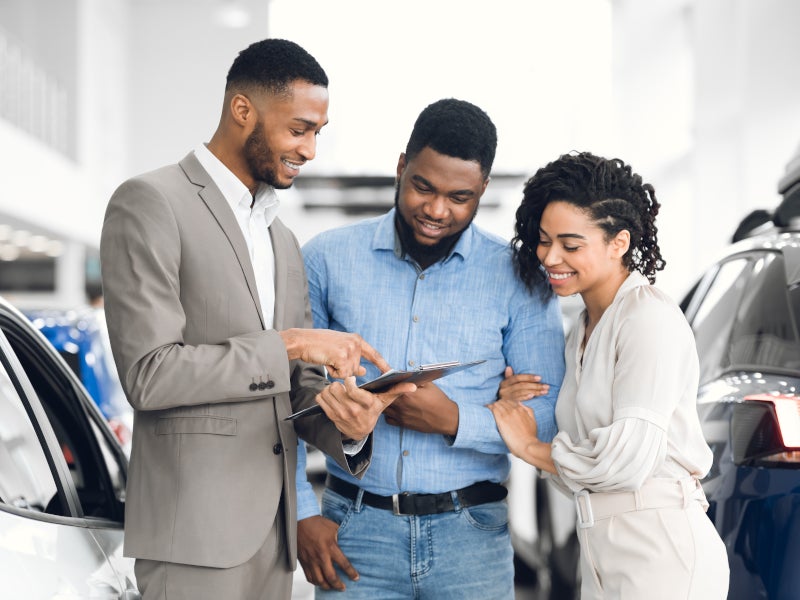 Couple at car dealership